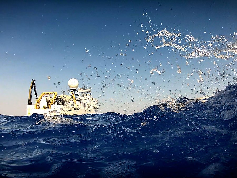 NOAA Ship Okeanos Explorer sitting in the ocean with waves splashing