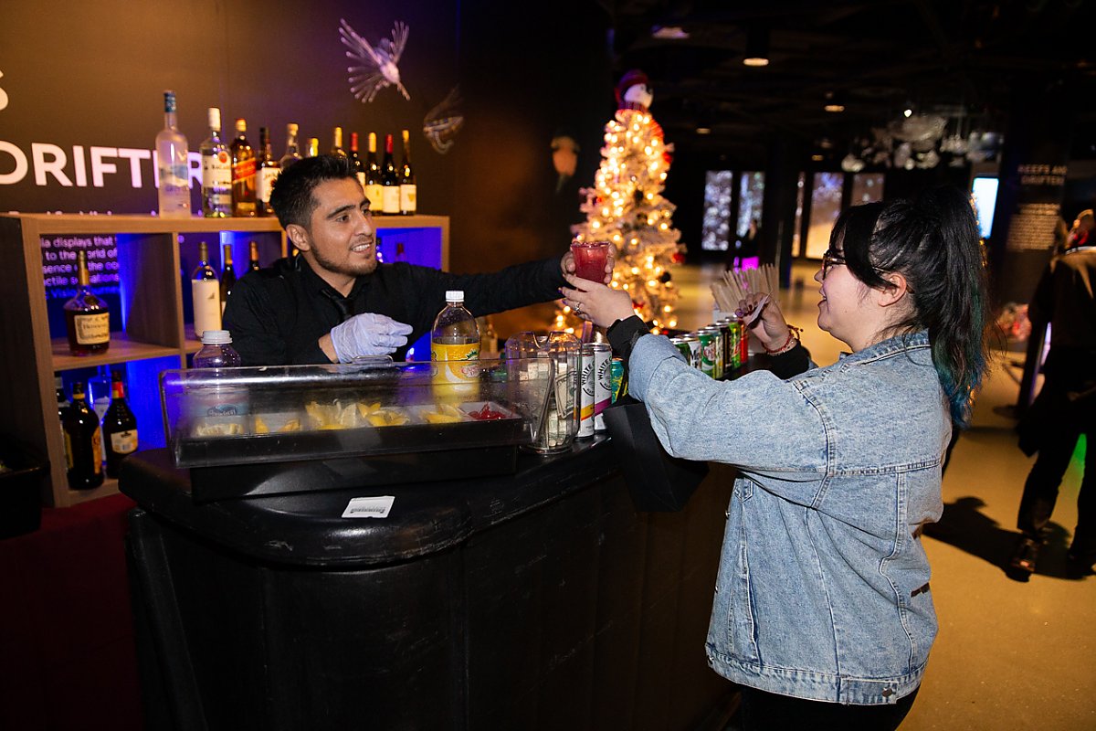 Woman at bar ordering drinks