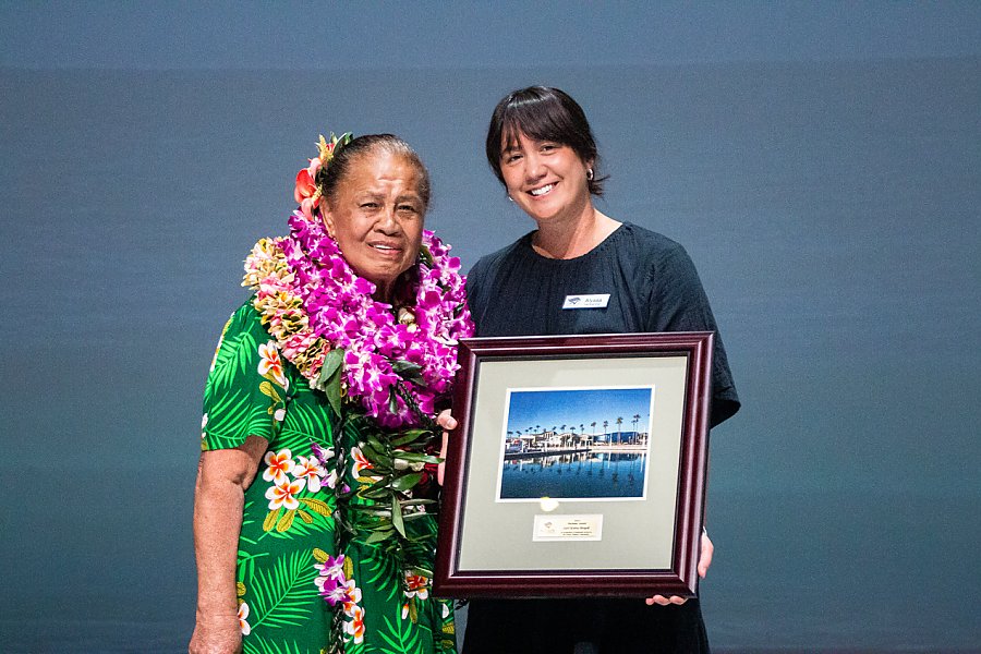 Two women holding award